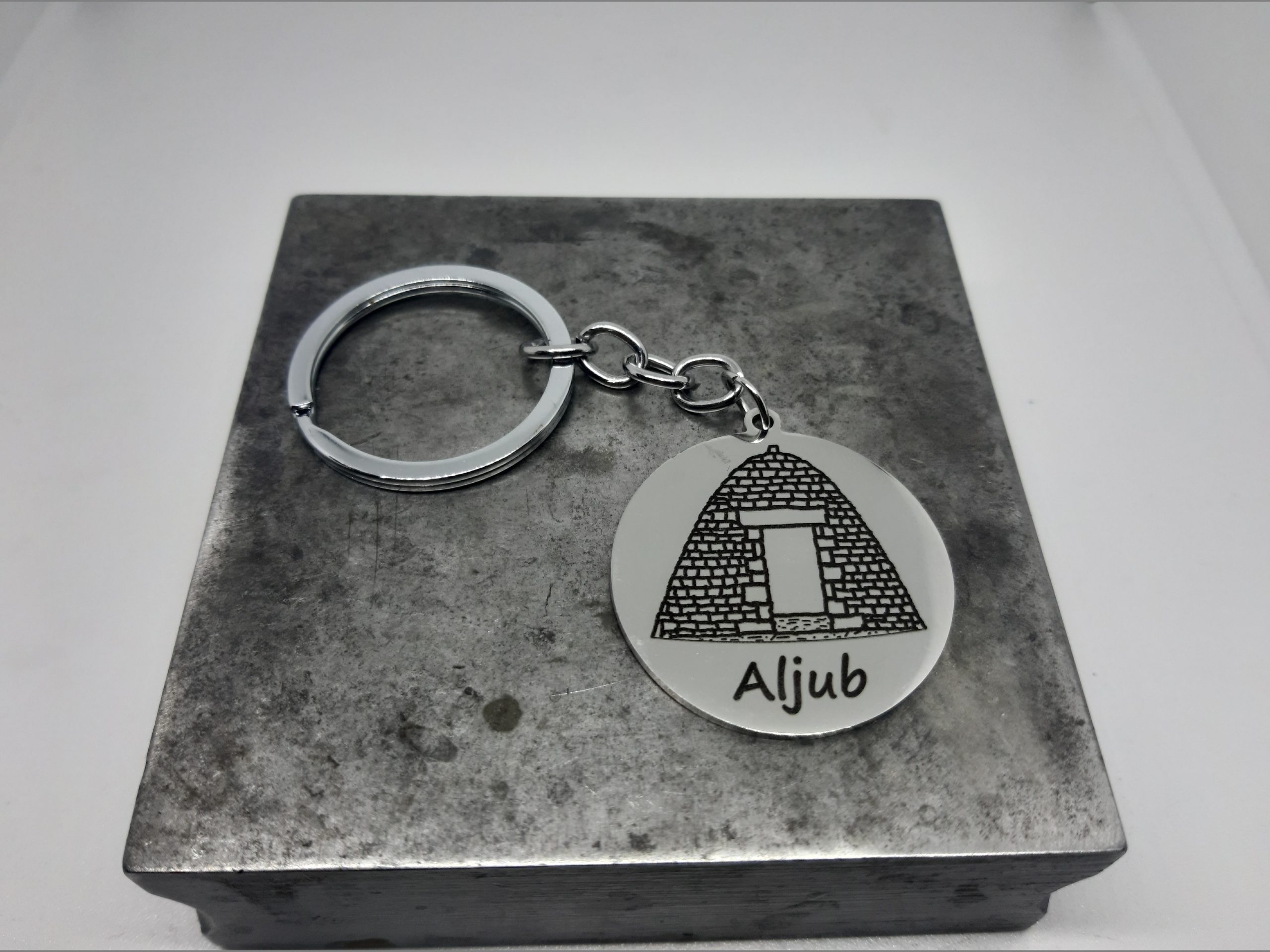 Clauer Acer dibuix Aljub sobre placa rodona